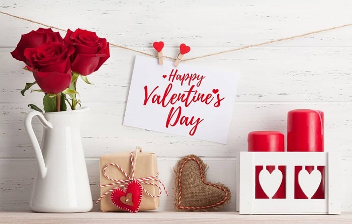 Valentine's Day gifts Ahmedabad romantic online delivery with red roses, heart decorations, candles, and gift box on white background