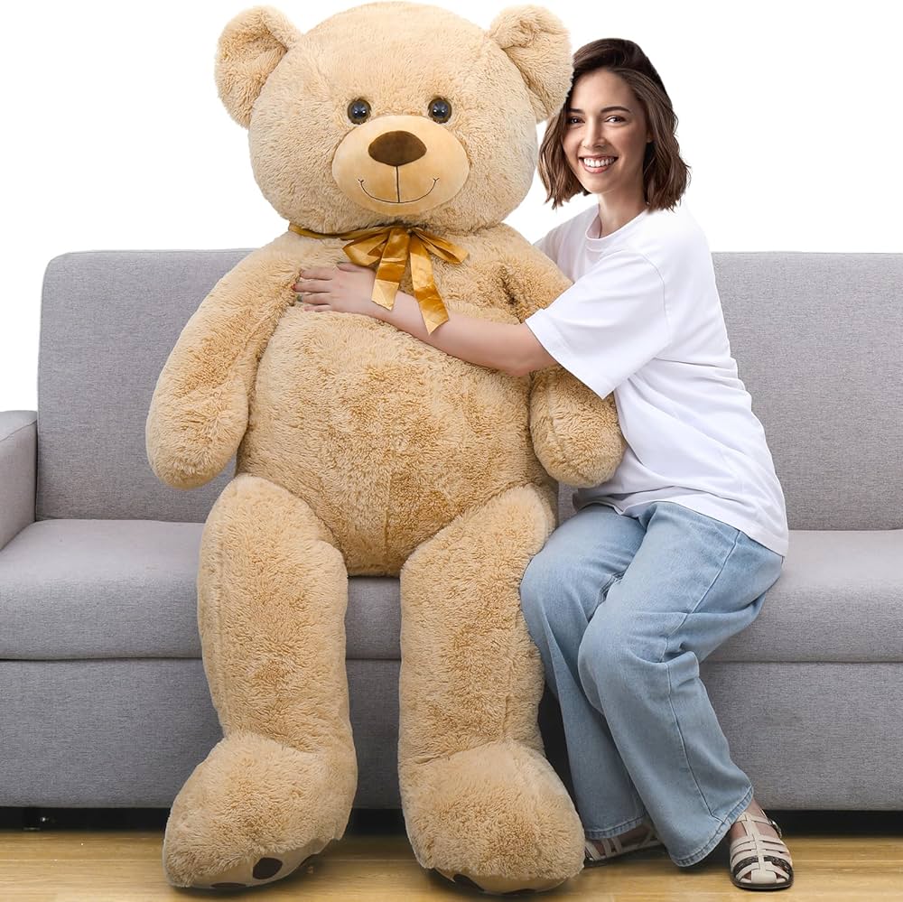 Woman hugging large beige teddy bear on sofa from samstoy.in large plush teddy bear for gift for all age in Ahmedabad Gujarat .