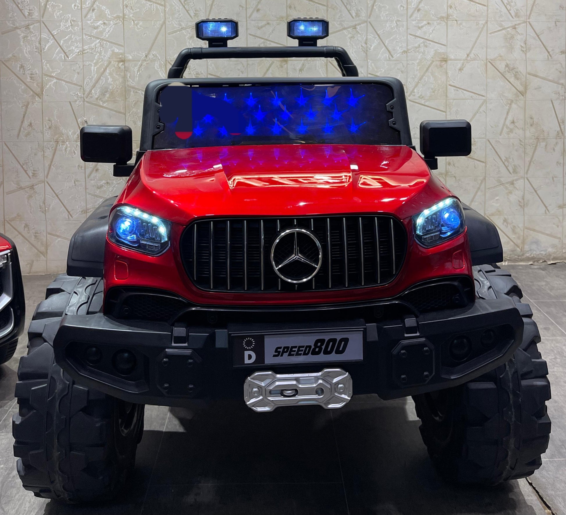 Red battery operated children's car make in Ahmedabad Gujarat by samstoy.in with bright blue headlights and rugged tires