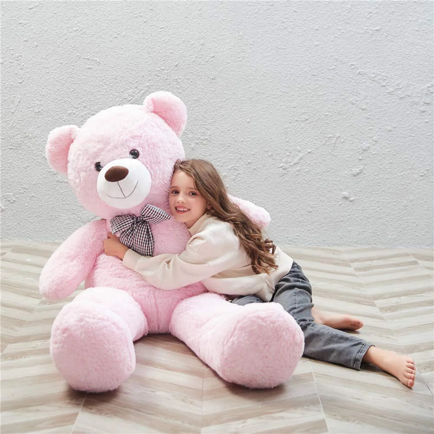 Big size soft plush teddy for girls Ahmedabad Gujarat India with a pink teddy bear hugged by a smiling child
