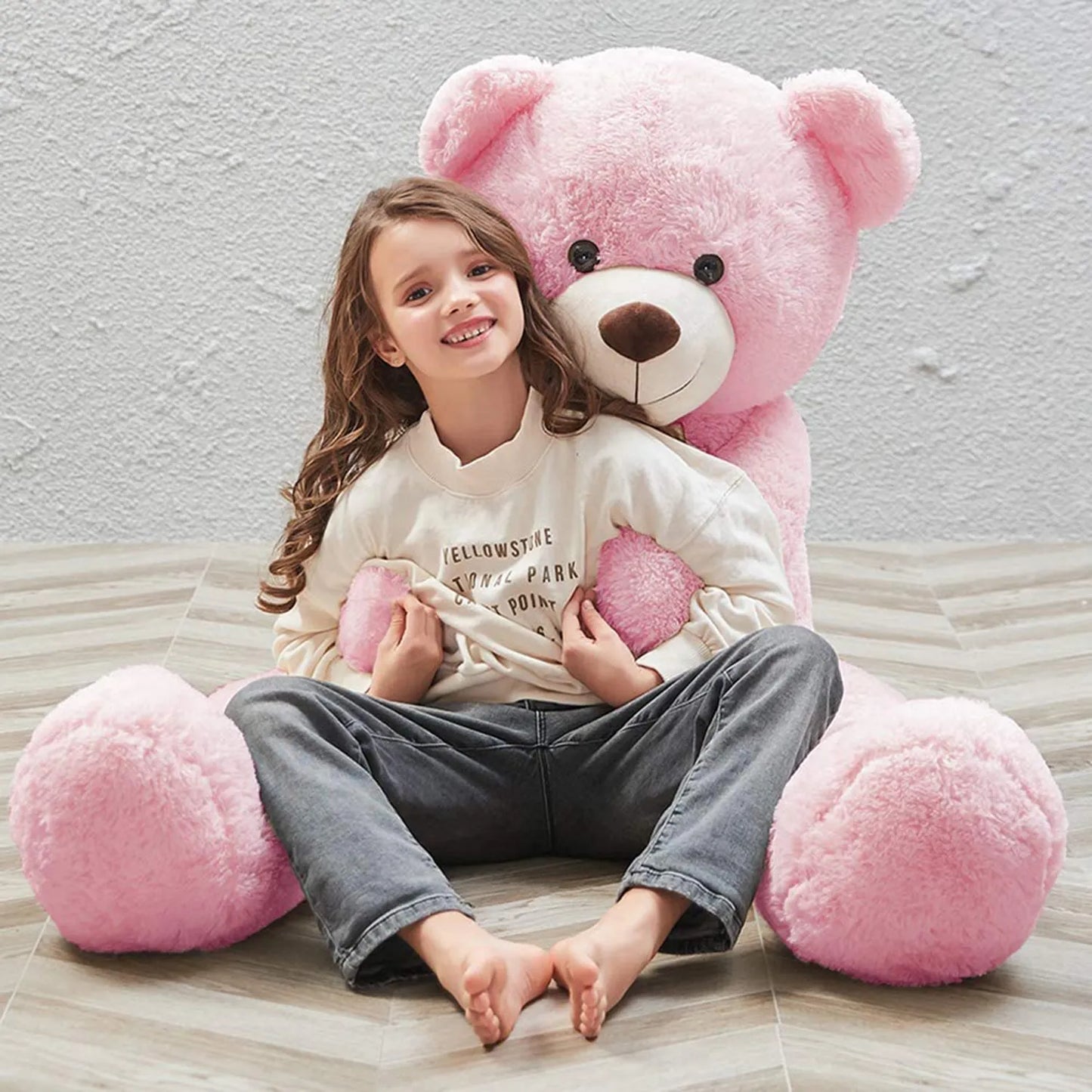Big size soft plush teddy for girls Ahmedabad Gujarat India with a smiling girl sitting in front