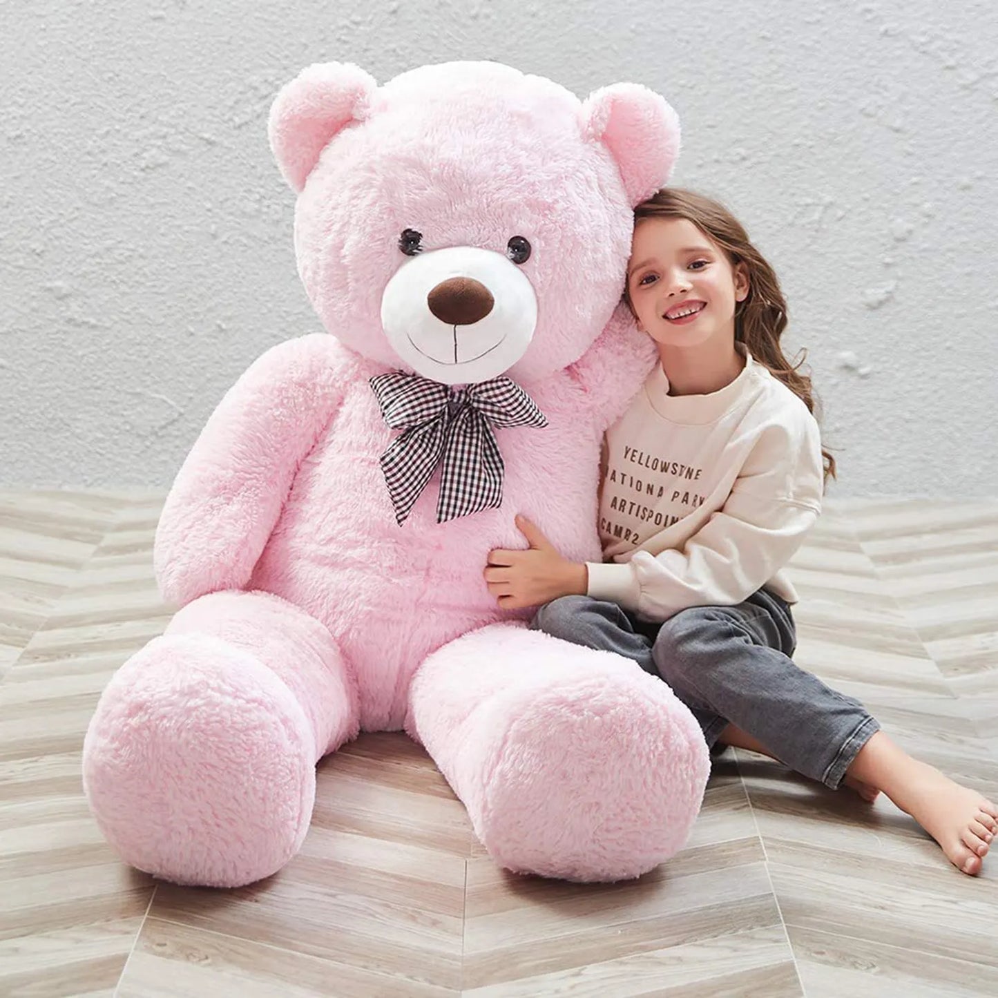 Big size soft plush teddy for girls Ahmedabad Gujarat India shown with smiling girl hugging large pink teddy bear