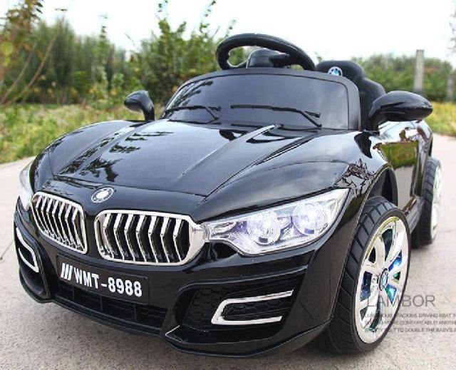Black children's ride on car with remote control designed like a luxury sports car with detailed front grille and headlights