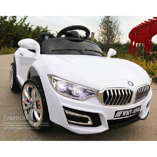 White children's ride on car with remote control designed like a luxury sports car with detailed headlights
