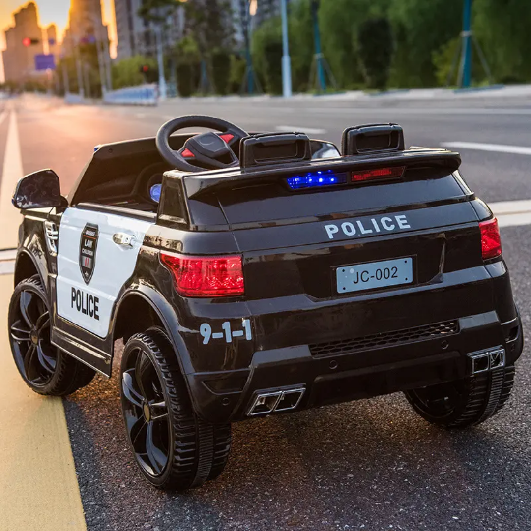 Black childs electric ride on car designed as a police vehicle, rear view, for kids to enjoy outdoor play