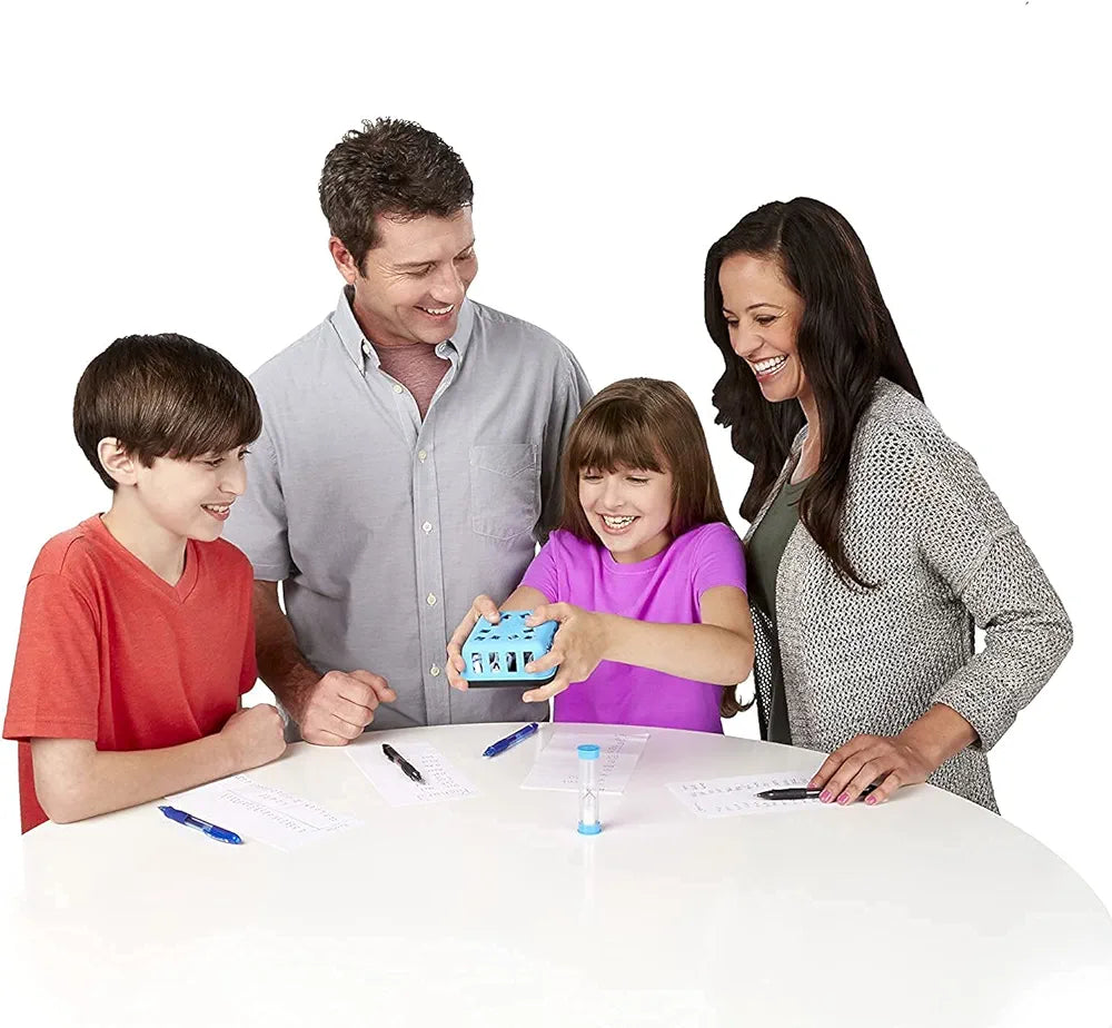 Family playing Boggle word game for kids around table with blue letter shaker and sand timer and score sheets