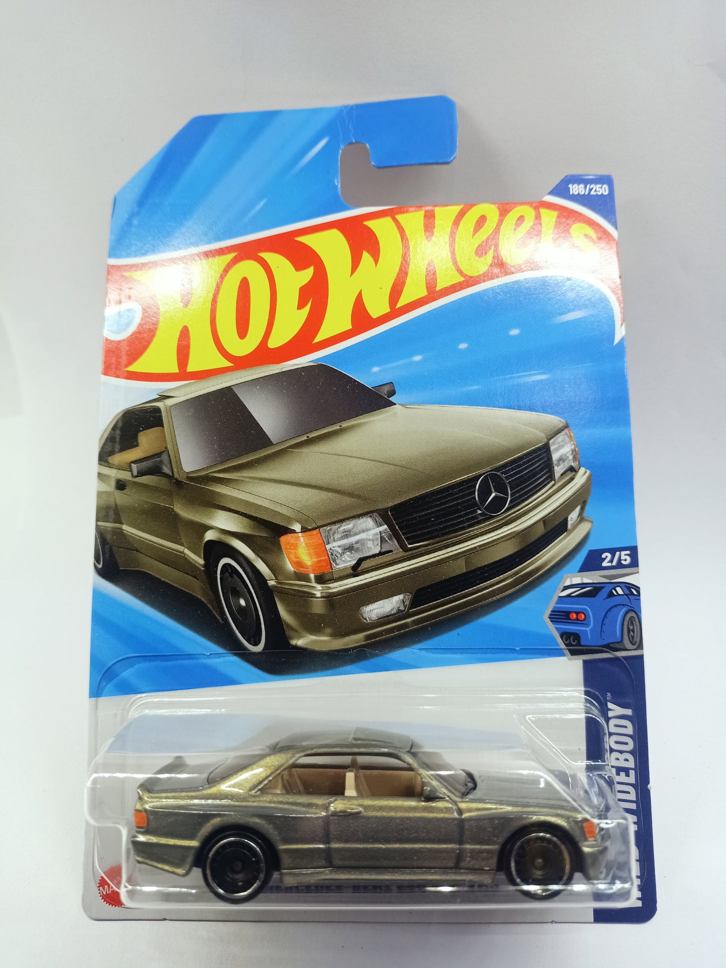 Buy Hot Wheels Mercedes-Benz 560 SEC diecast car toy in gold color with black wheels in packaging