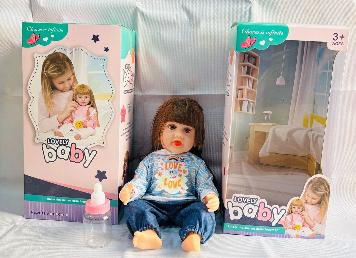 realistic baby doll with accessories silicone real Doll Ahmedabad lifelike seated baby doll in blue outfit with box and bottle