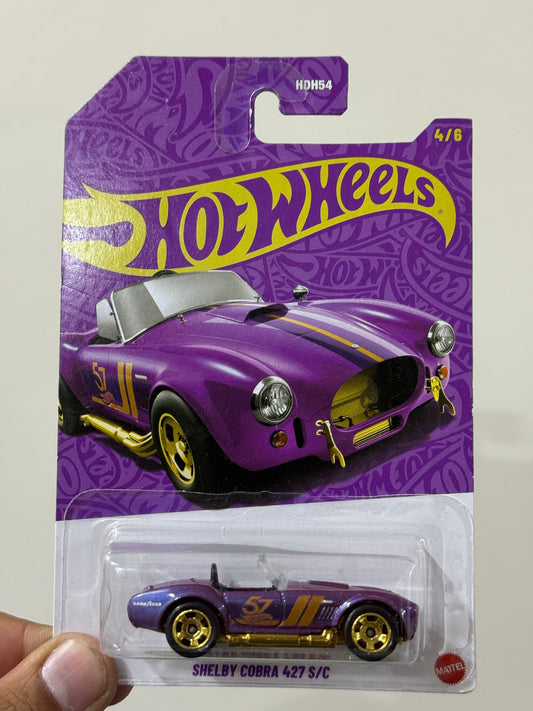 Hot Wheels Shelby Cobra 427 S/C purple Ahmedabad Gujarat online India . Purple toy car on card packaging with gold stripes