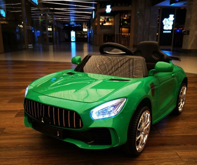 Green remote control kids car 1-8 years with detailed headlights and sporty design on wooden floor