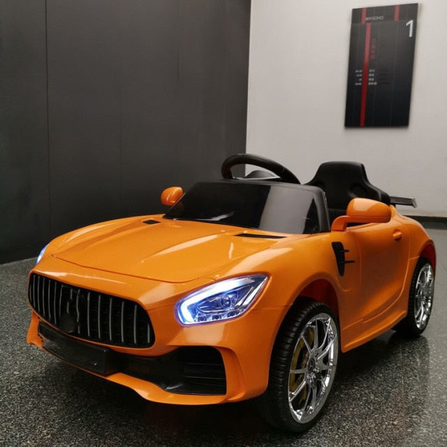 Orange remote control kids car 1-8 years with realistic design and LED headlights indoors