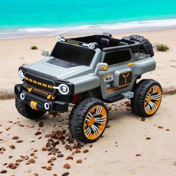Remote control 3 seater jeep jumbo big size by Sam's Ahmedabad in gray with orange-accented wheels on beach sand
