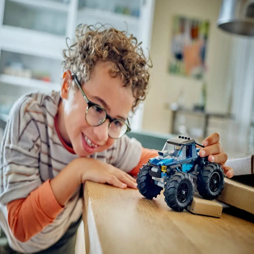 Buy LEGO City toys online India Sam's Toy World Ahmedabad 8 year old boy playing with blue LEGO monster truck on table
