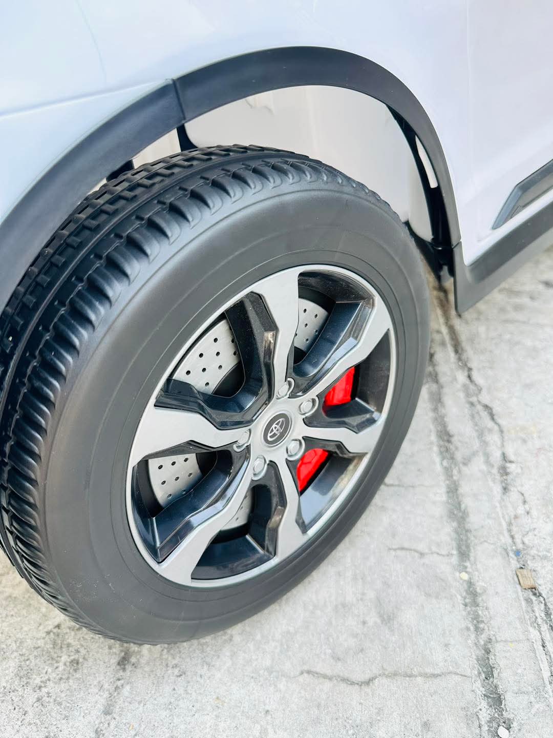Close-up of 2026 Toyota Innova battery operated ride-on car wheel with stylish alloy design and red brake calipers