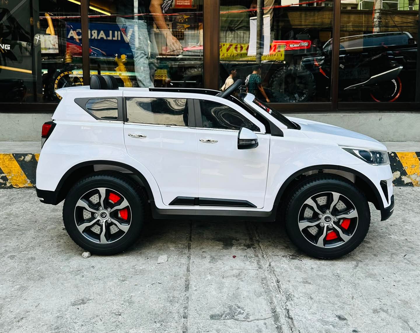 White 2026 Toyota Innova battery operated ride-on car with detailed exterior design and stylish wheels