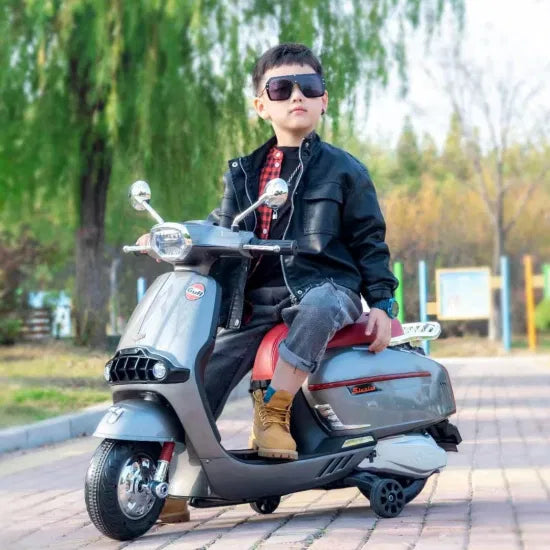 Battery Gulf scooter for kids Ahmedabad Gujarat in stylish grey design with a child riding wearing sunglasses