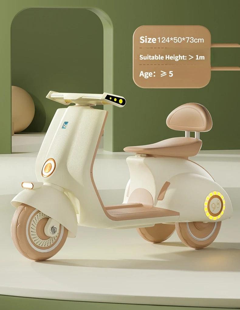 Battery operated kids scooter Ahmedabad Gujarat India in cream and beige color with seat and three wheels for children above 5 years