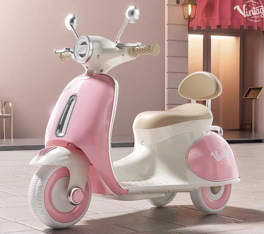 Pink vintage-style electric scooter for kids at Sam's Toy World Ahmedabad, side view, perfect for fun rides