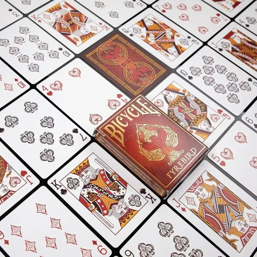 Bicycle playing cards in red box placed on a table with various playing cards, perfect for games in playing cards