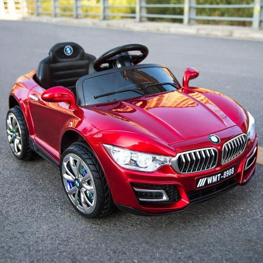 Red children's ride on car with remote control styled like a luxury sports car on pavement