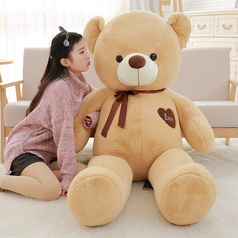 Woman sitting next to a big large teddy bear with a brown ribbon buy big large teddy bear online Ahmedabad