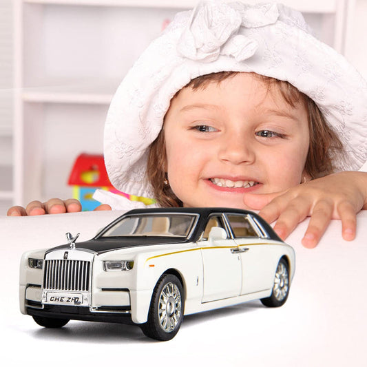 Child playing with white Rolls Royce Phantom diecast model car with lights and music. Toy model on table