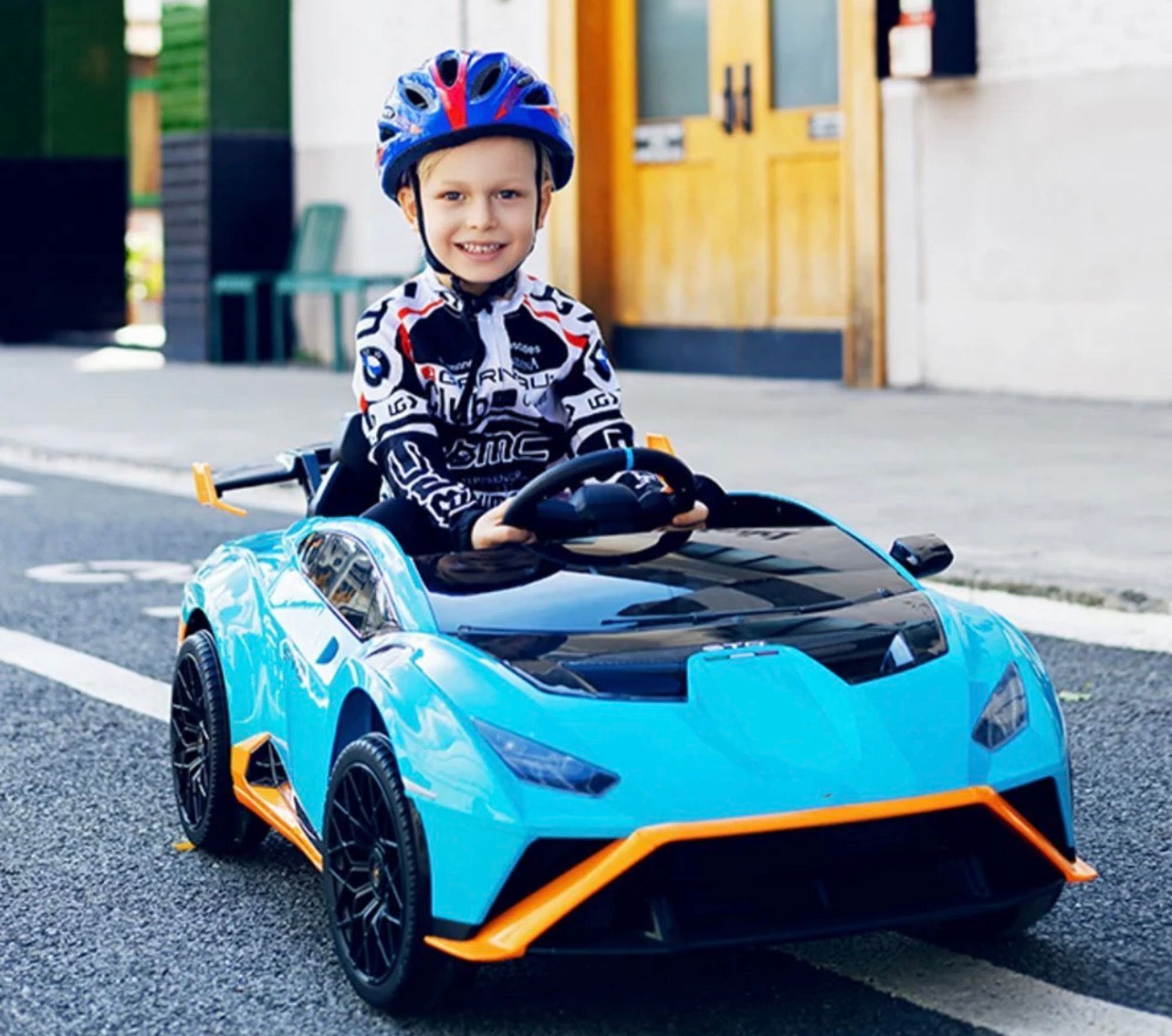 Blue childs electric ride on car with sporty design, front view, perfect for outdoor fun and play