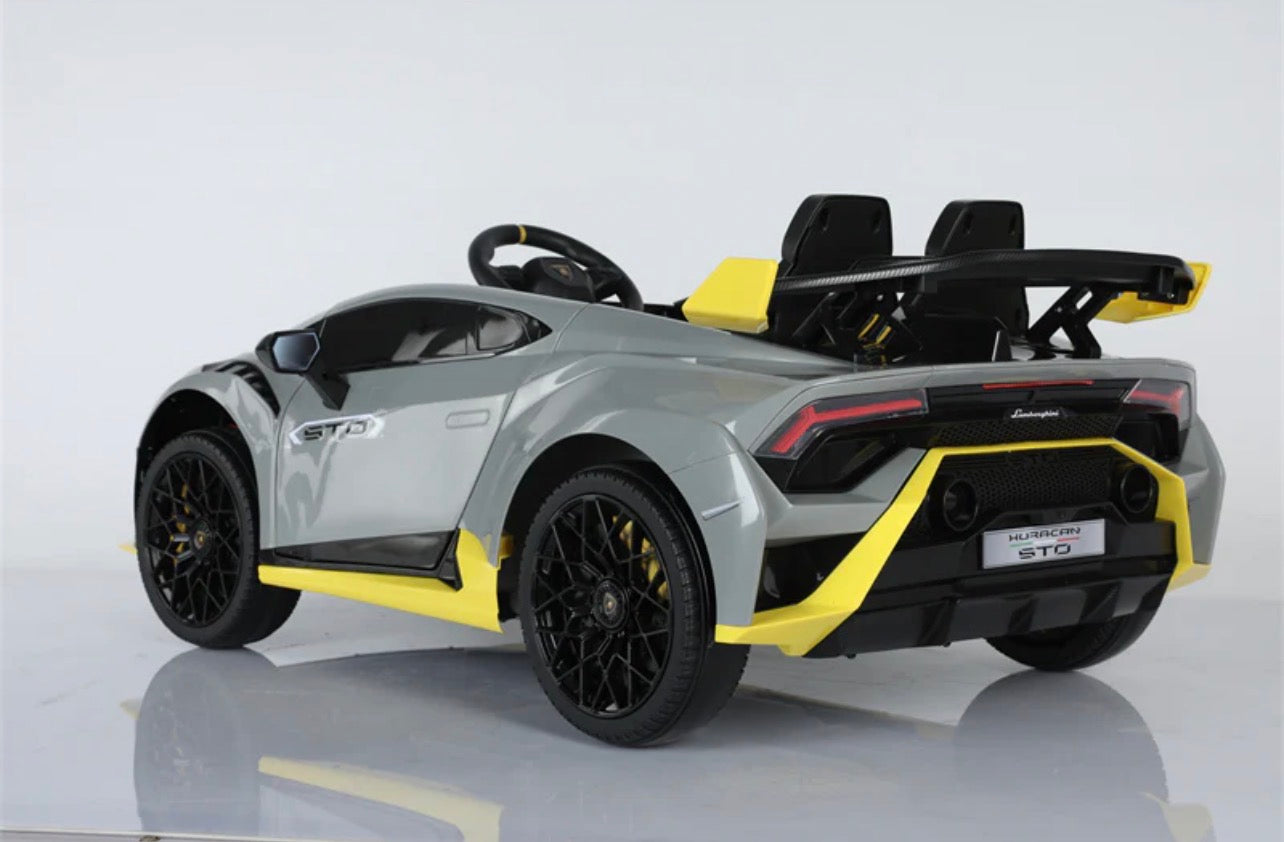 Gray child's electric ride on car with yellow accents, rear view, for outdoor play and fun