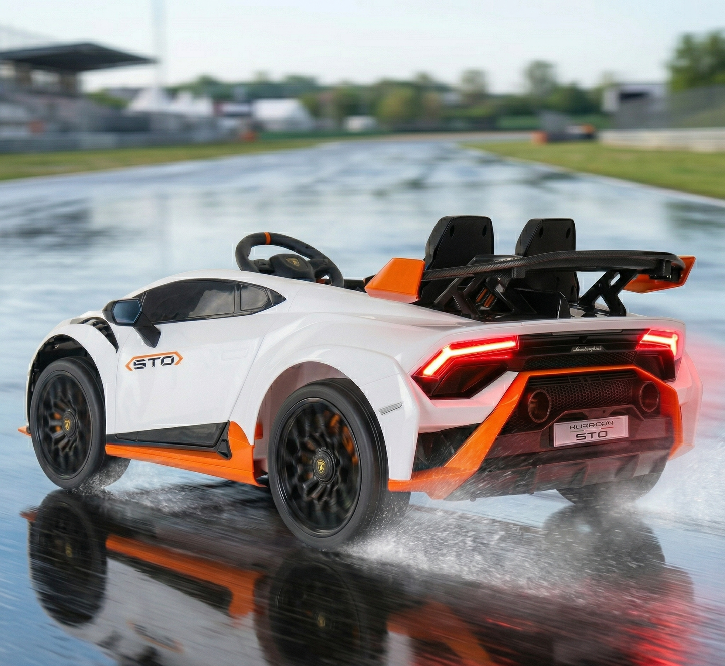 White and orange childs electric ride on car, rear view, ideal for outdoor fun and imaginative play