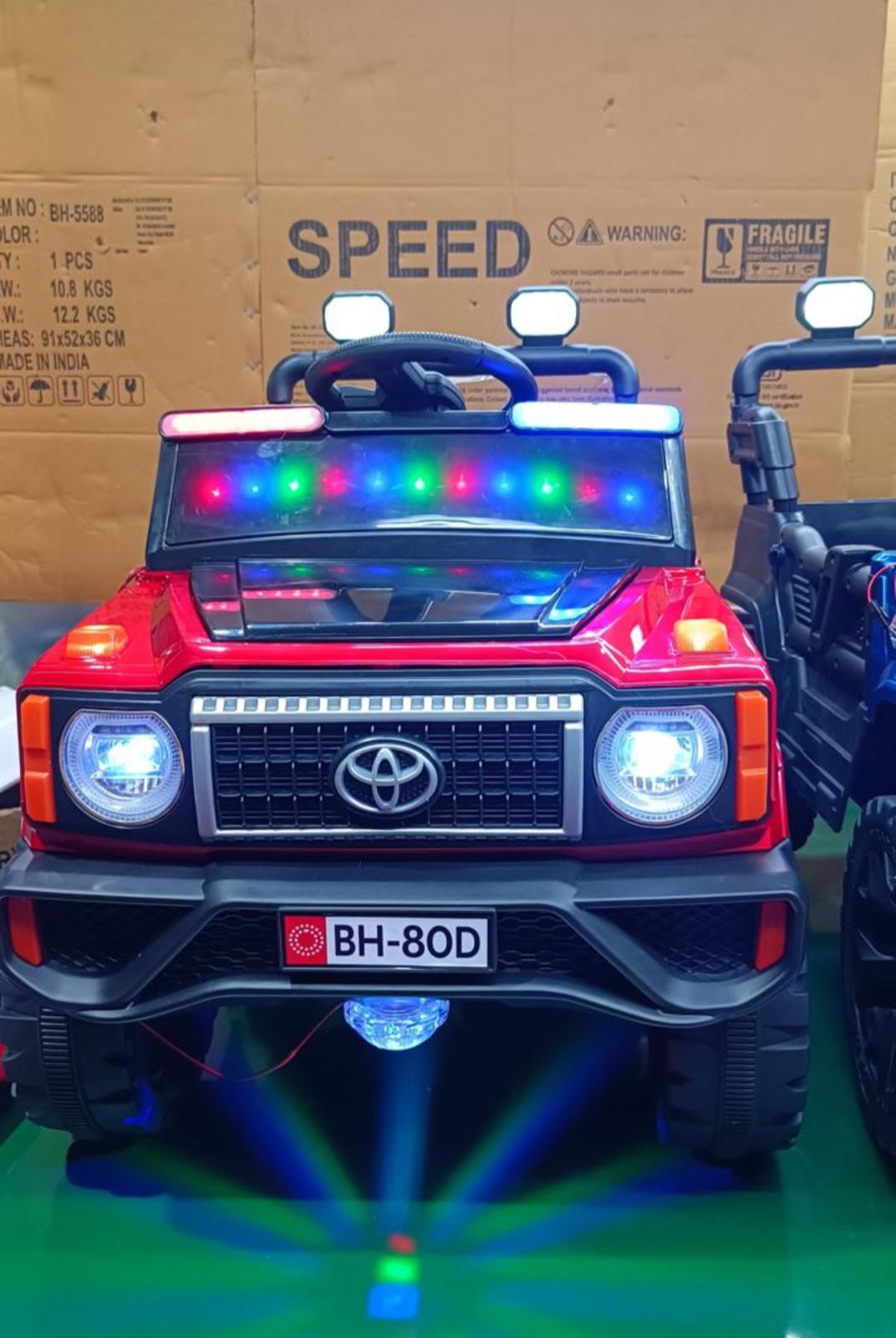 Red childs ride on jeep in Ahmedabad with LED lights, front view, for outdoor fun and adventure