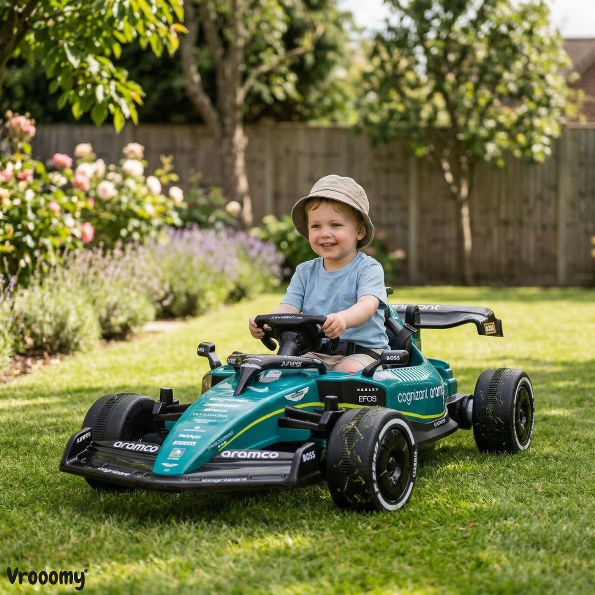 Green kids battery operated car Formula 1, front view, for outdoor fun and play in the garden
