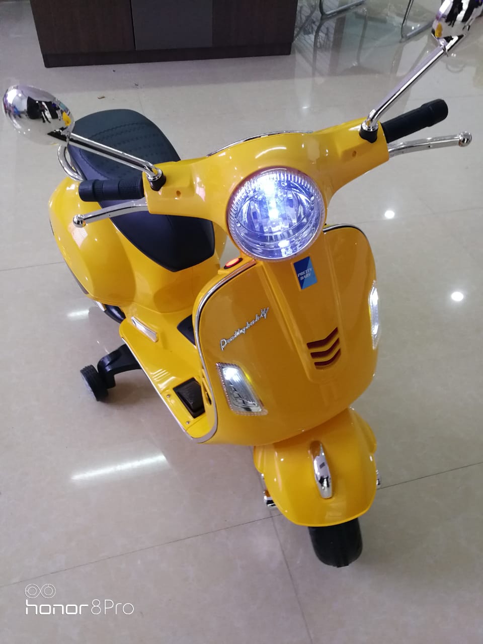 Yellow Kids Vespa Scooter with working lights for ages 3-7 from Sam's Toy World; battery scooter for kids in Ahmedabad Gujarat