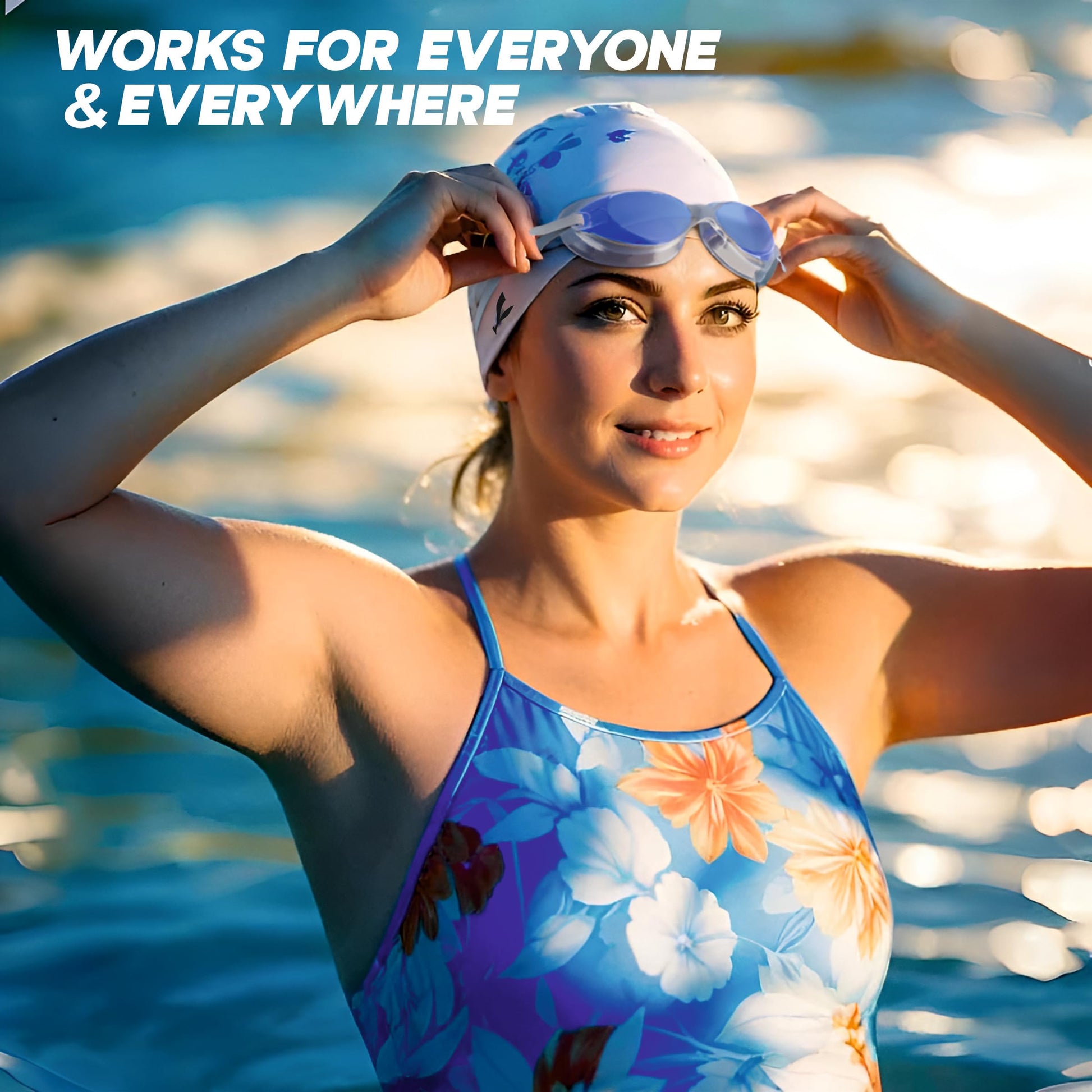 Woman preparing to swim wearing anti-fog swimming goggles for adults and kids with a floral swimsuit