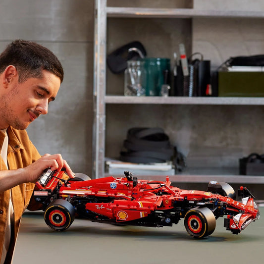 Man assembling red LEGO Technic Ferrari SF-24 F1 car in Gujarat online India model showing intricate details