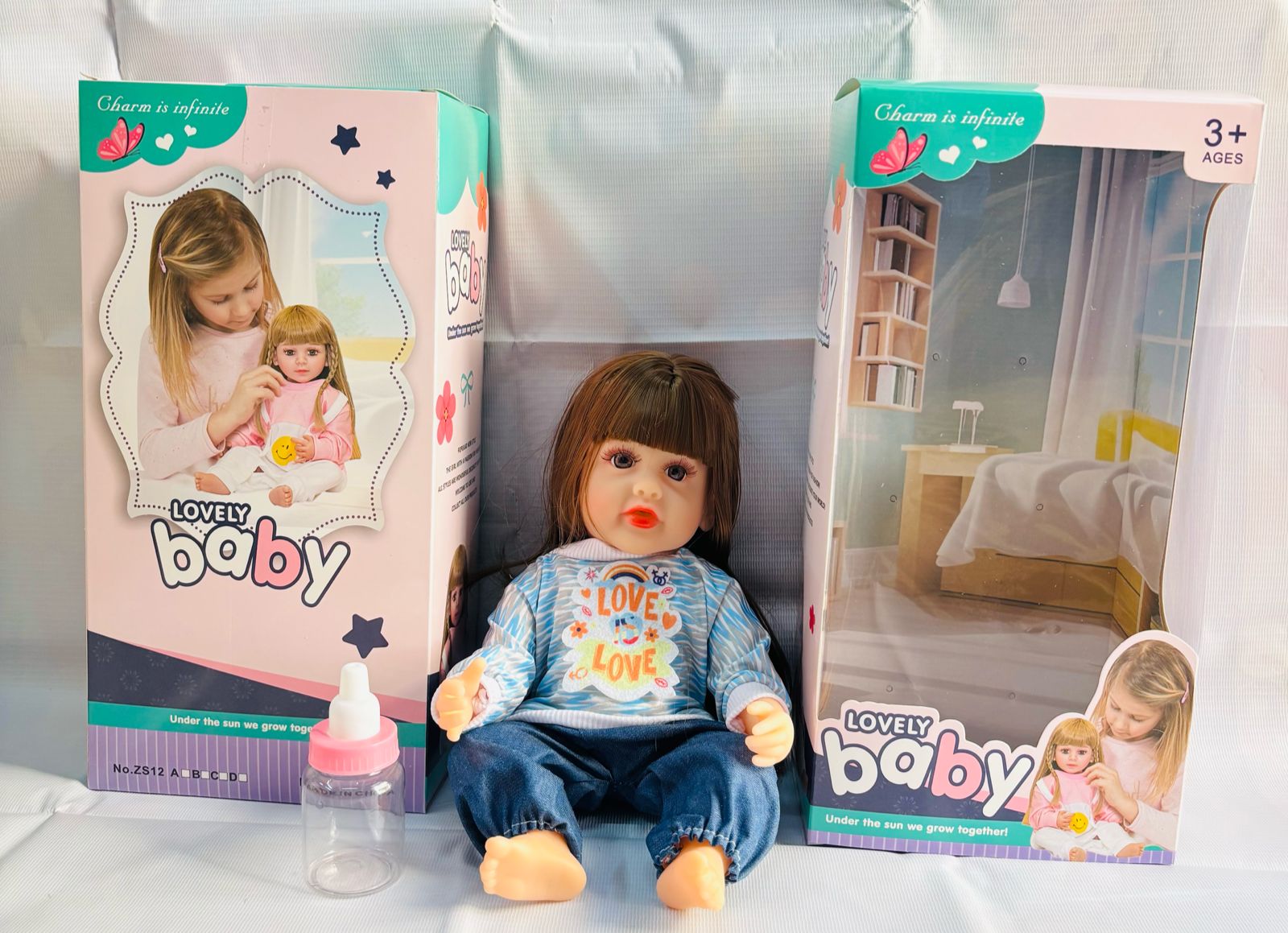 realistic baby doll with accessories silicone real Doll Ahmedabad lifelike seated baby doll in blue outfit with box and bottle