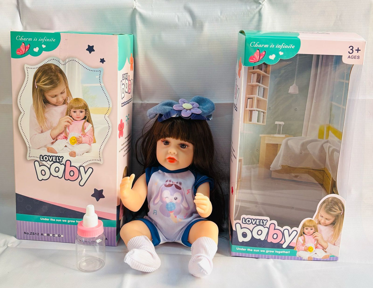 realistic baby doll with accessories silicone real Doll Ahmedabad . lifelike baby doll in blue outfit with bottle and packaging