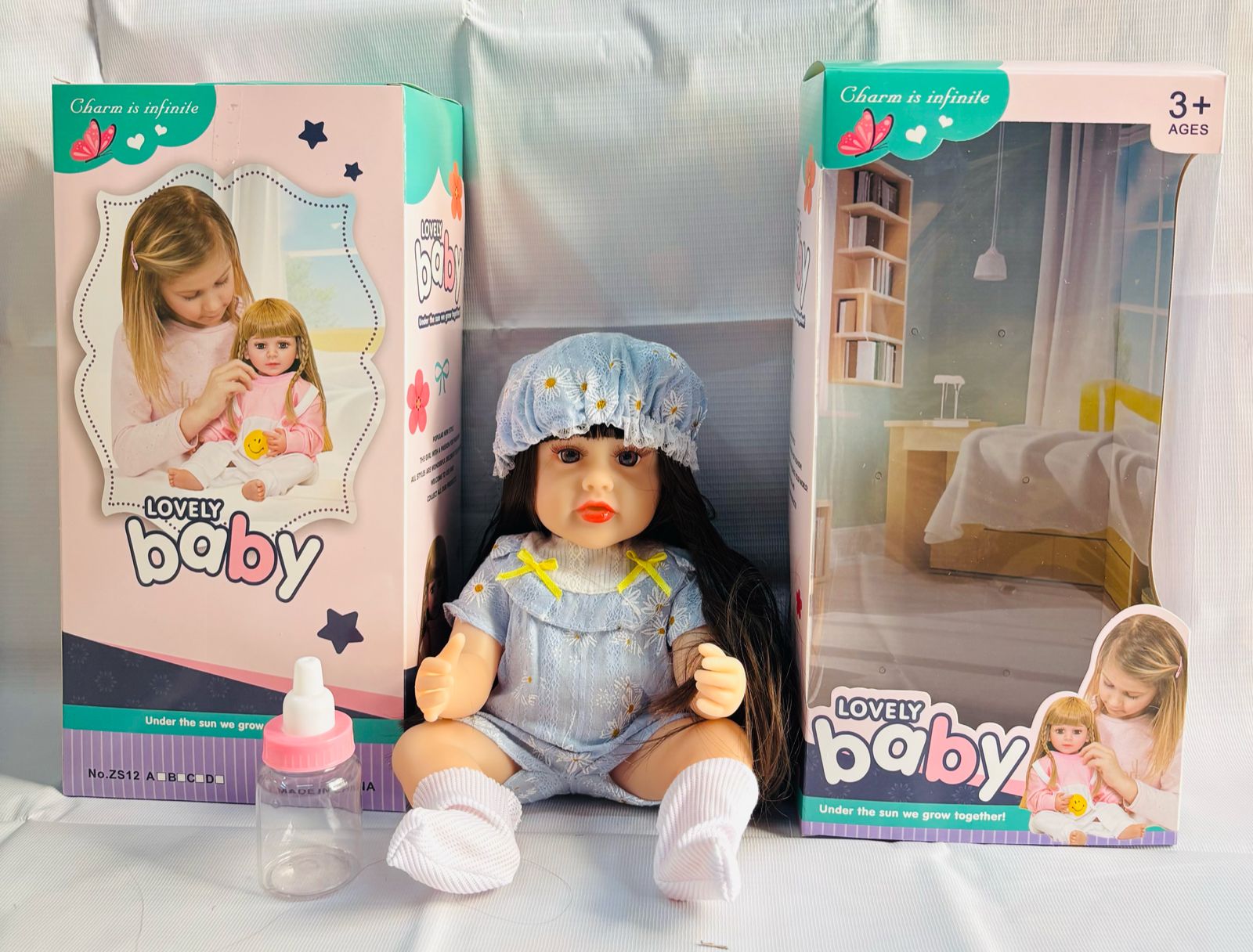 realistic baby doll with accessories silicone real Doll Ahmedabad . Lifelike doll in blue outfit with bonnet bottle box