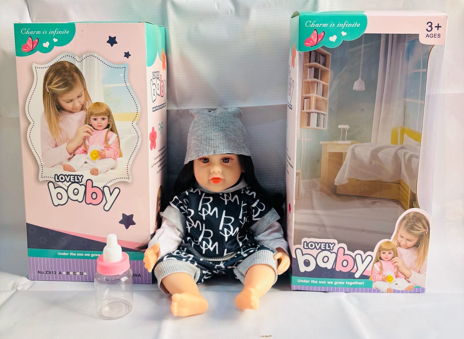 realistic baby doll with accessories silicone real Doll Ahmedabad . Lifelike black haired baby doll with hat bottle and box