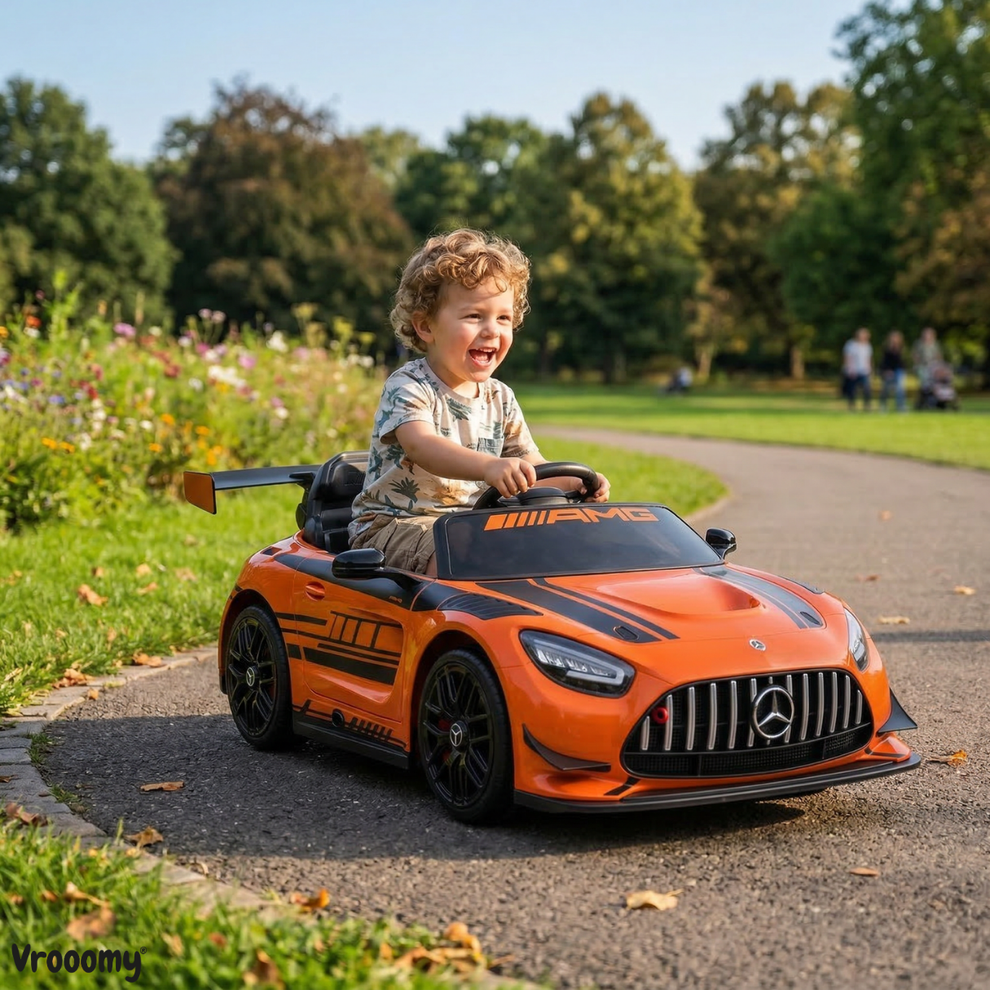 Orange Mercedes-AMG kids battery operated car, front view, perfect for outdoor play and fun rides