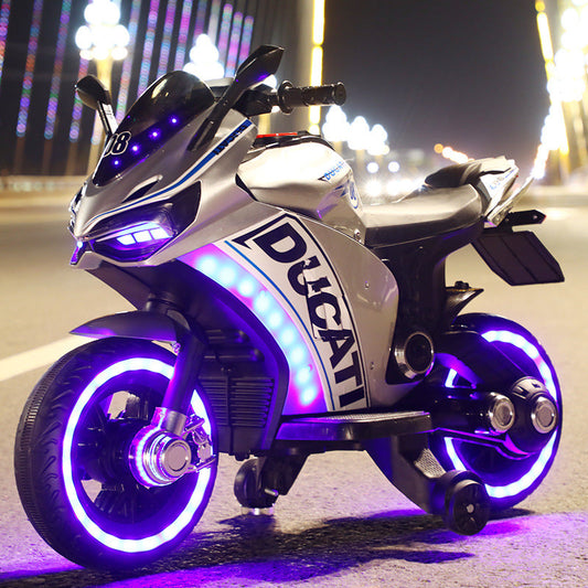 White Ducati style battery operated ride on bike for children with purple LED wheels and training wheels