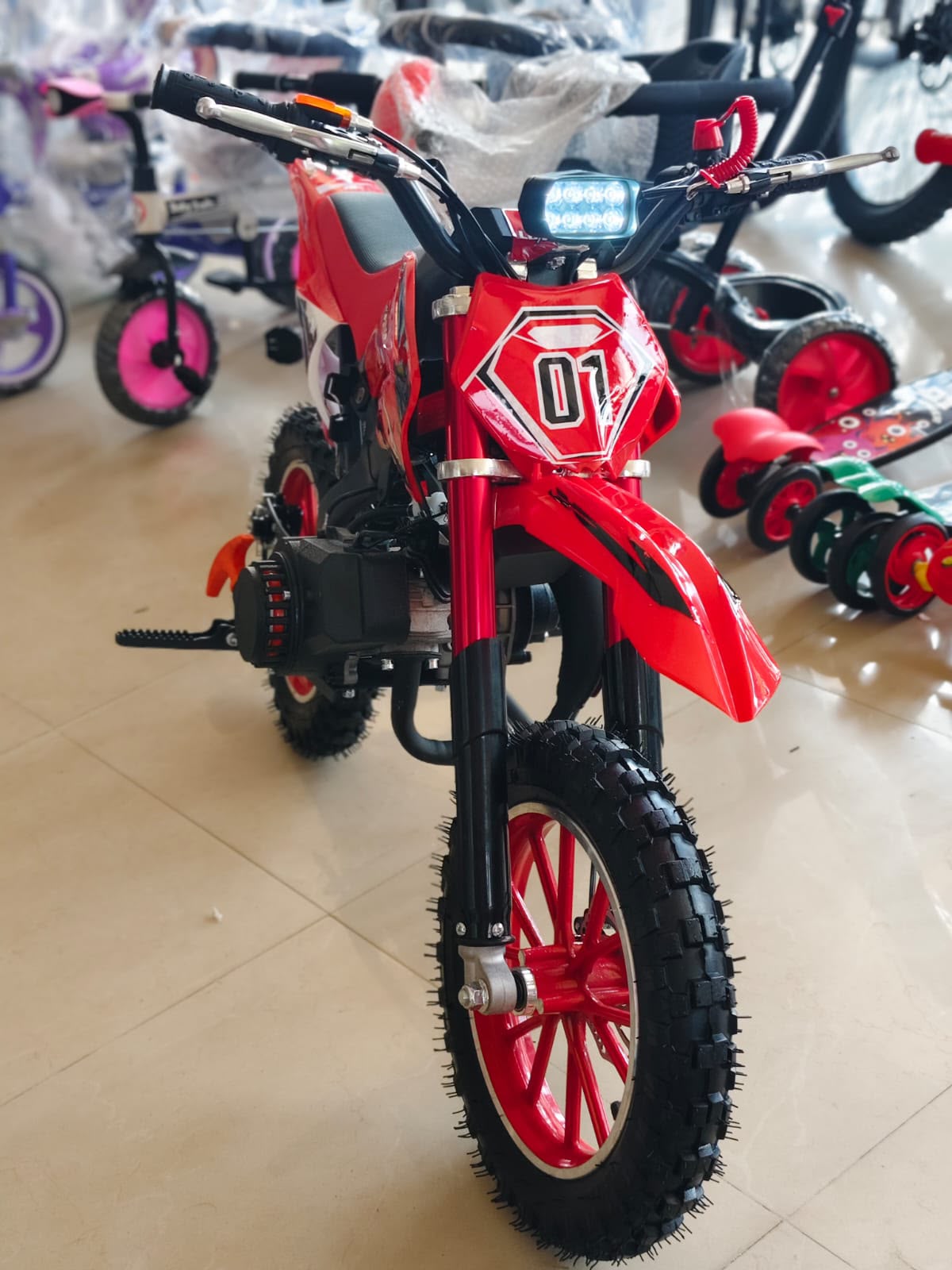 Red Moto dirt bike dirt bike 50cc petrol bike for kids in Ahmedabad, front view with rugged tires