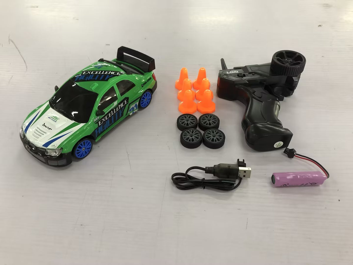 Green and blue remote control car with remote, battery, wheels, and cones for racing fun