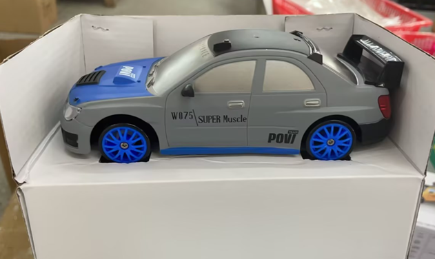 Gray and blue remote control car with remote, top view, ideal for children and outdoor play.