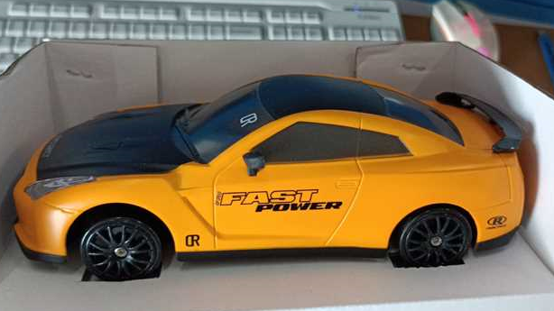 Yellow remote control car with remote, side view, perfect for speed enthusiasts and kids alike