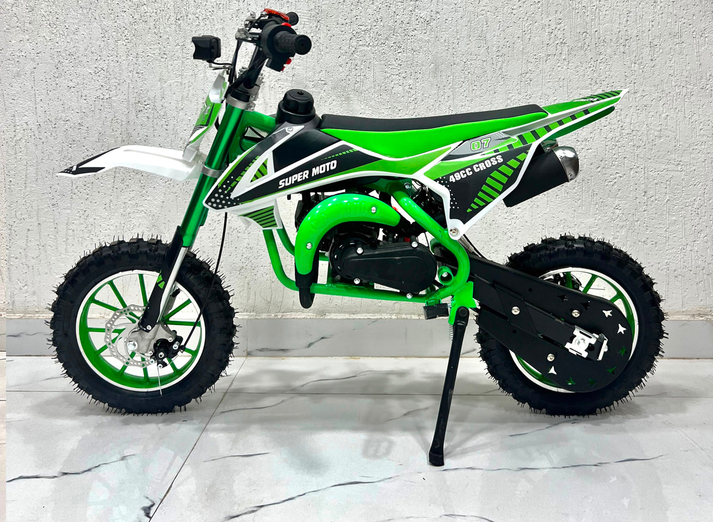 Green 49cc dirt bike in Ahmedabad by Sam's Toy World, side view for young riders and outdoor adventures