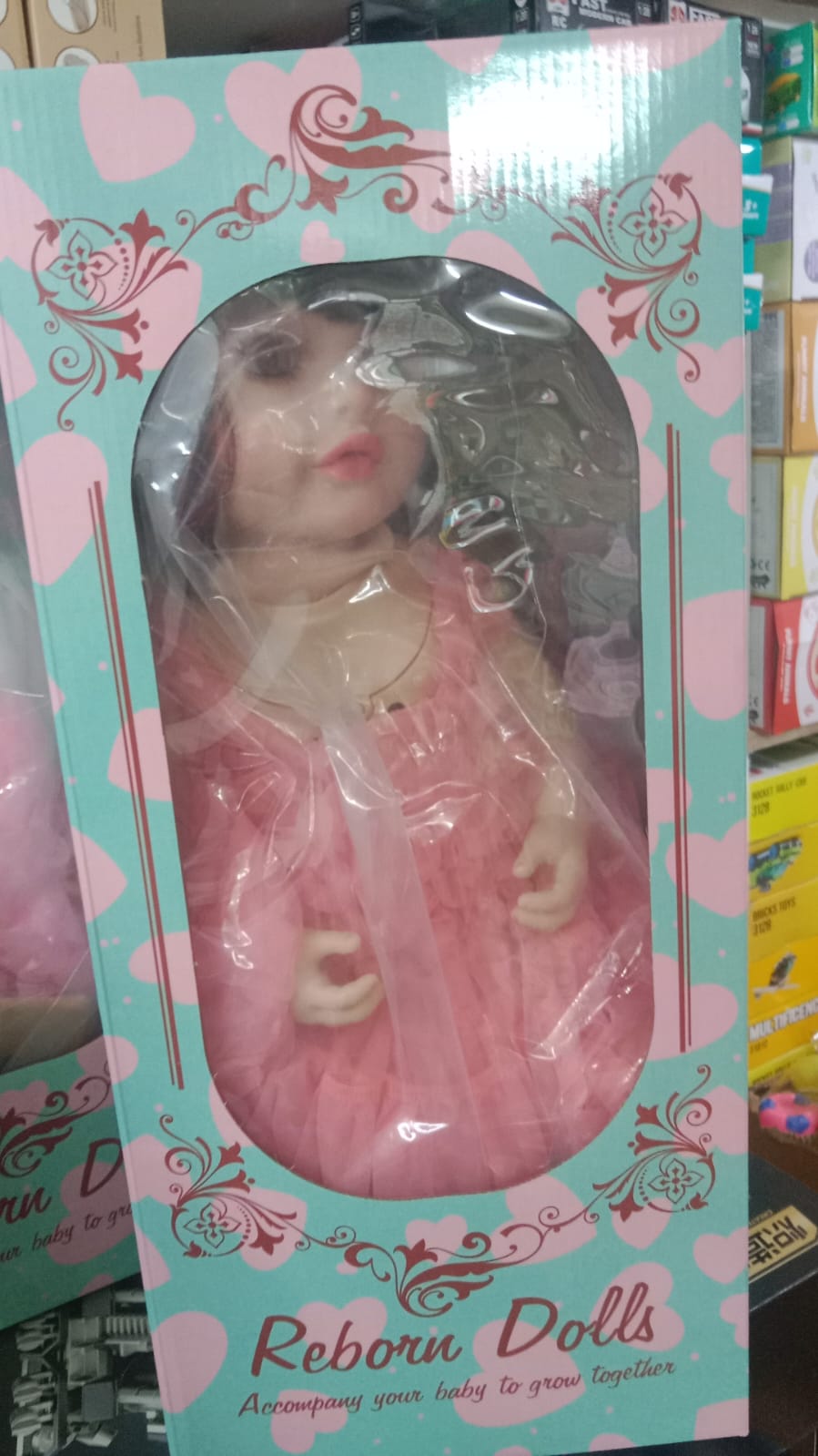 Silicon Doll. Real Baby Doll, Ai Doll Toy in Ahmedabad in a pink dress by Sam's Toy World for ages 3 and up