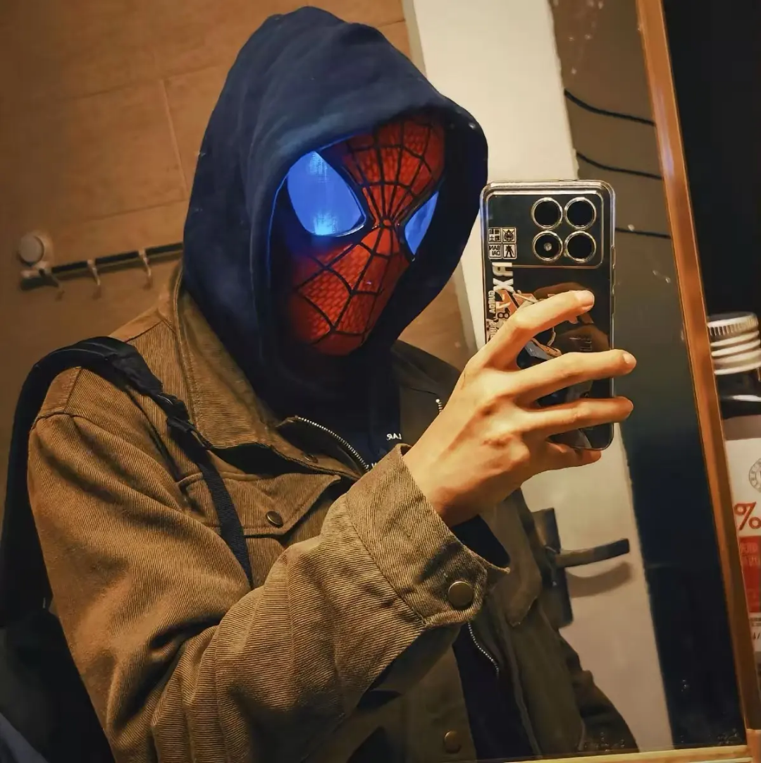 Spiderman mask light, red and black design, worn in mirror selfie, perfect for superhero enthusiasts