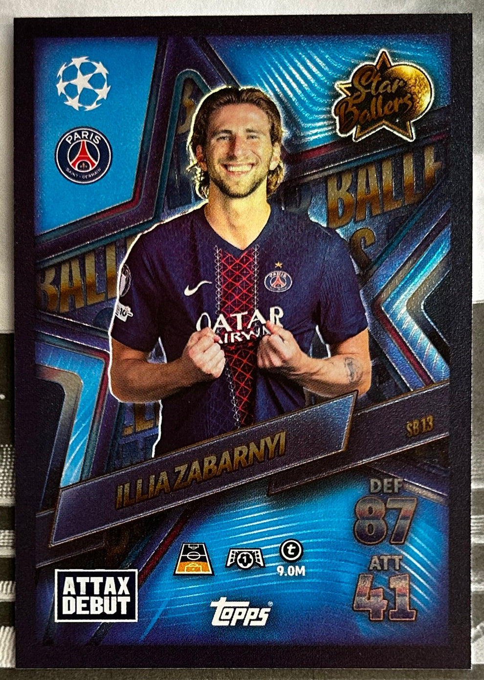 Topps Match Attax trading card featuring Illia Zabarnyi in Paris jersey, showcasing stats and debut details